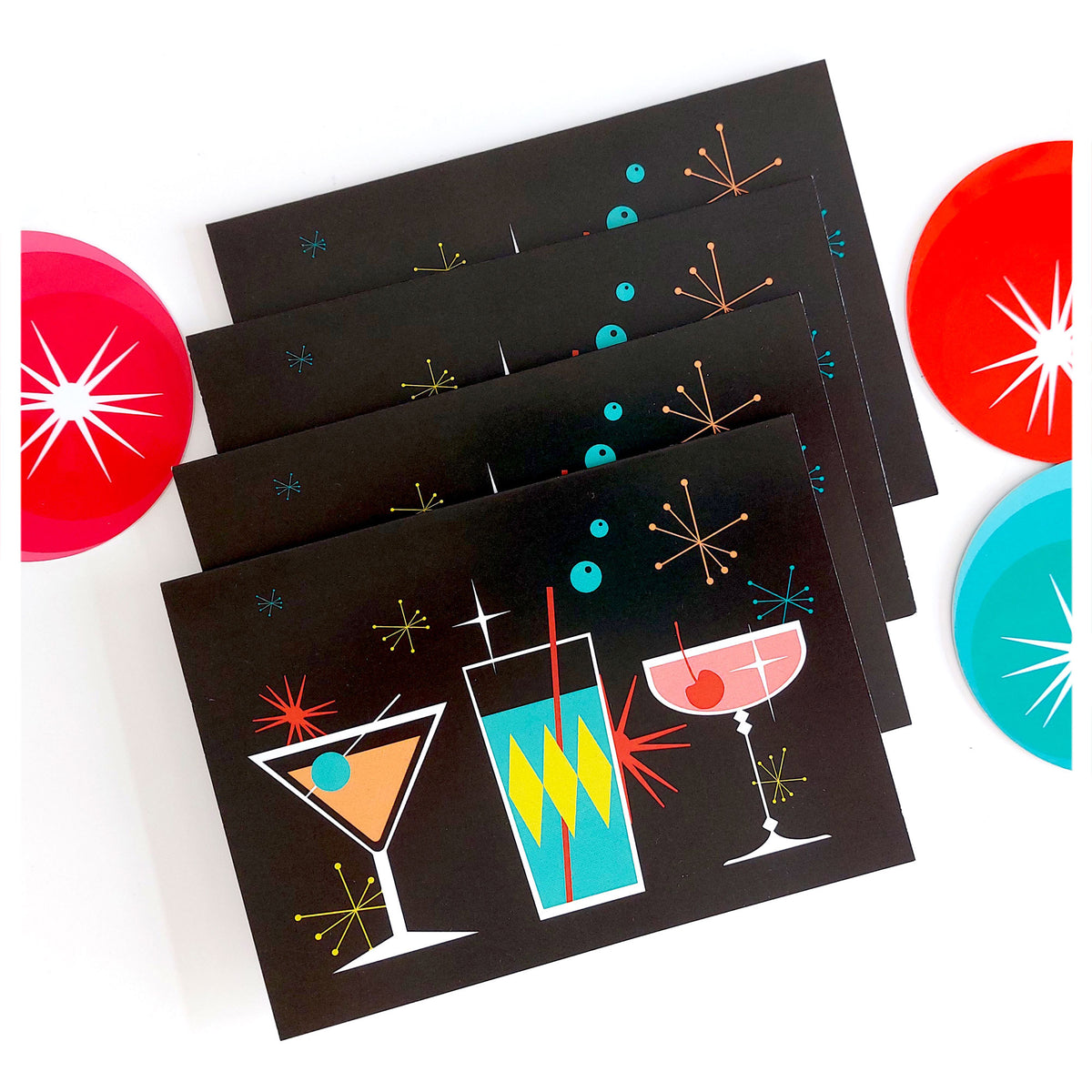 Four Cosmic Cocktails Christmas Cards, on a white table with retro Christmas decorations | The Inkabilly Emporium