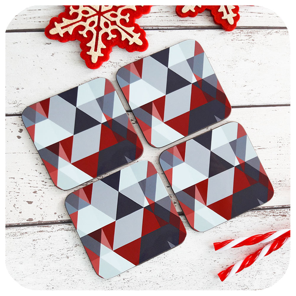 Scandi Geometric Coasters in Grey & Red, set of four, on table with Christmas decor | The Inkabilly Emporium