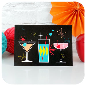 Cosmic Cocktails Card on table with retro party decorations | The Inkabilly Emporium