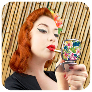 Photo of vintage style pin-up model Miss Jessica Holly applying lipstick and looking at herself in a compact mirror | The Inkabilly Emporium