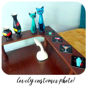 Customer photo of Cosmic Cocktails Coasters on Mid Century table with vintage china cats and vases | The Inkabilly Emporium