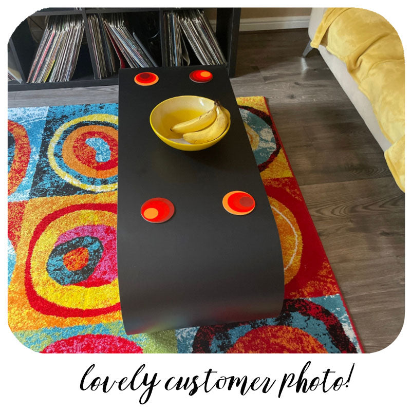 Customer photo of 70s Circles Coasters on black coffee table on colourful rug | The Inkabilly Emporium
