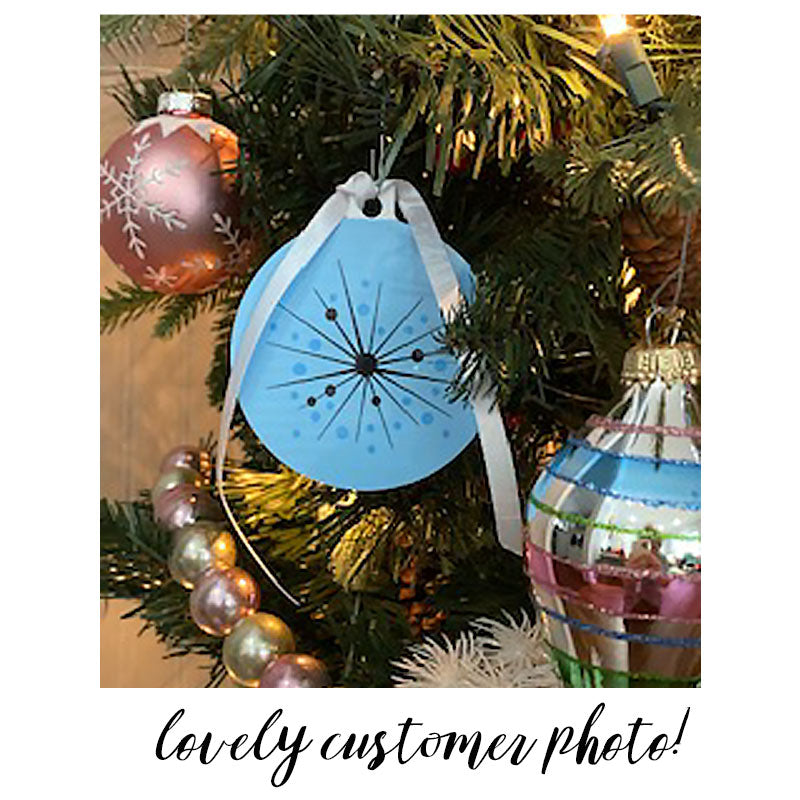 Customer Photo of our Atomic Style Christmas Tree Decoration in Pastel Blue, hanging on a Christmas Tree | The Inkabilly Emporium