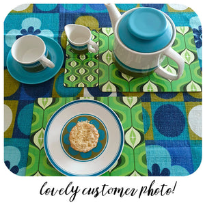 Customer photo of Green Op Art placemats and coasters on a 70s table cloth with vintage crockery
