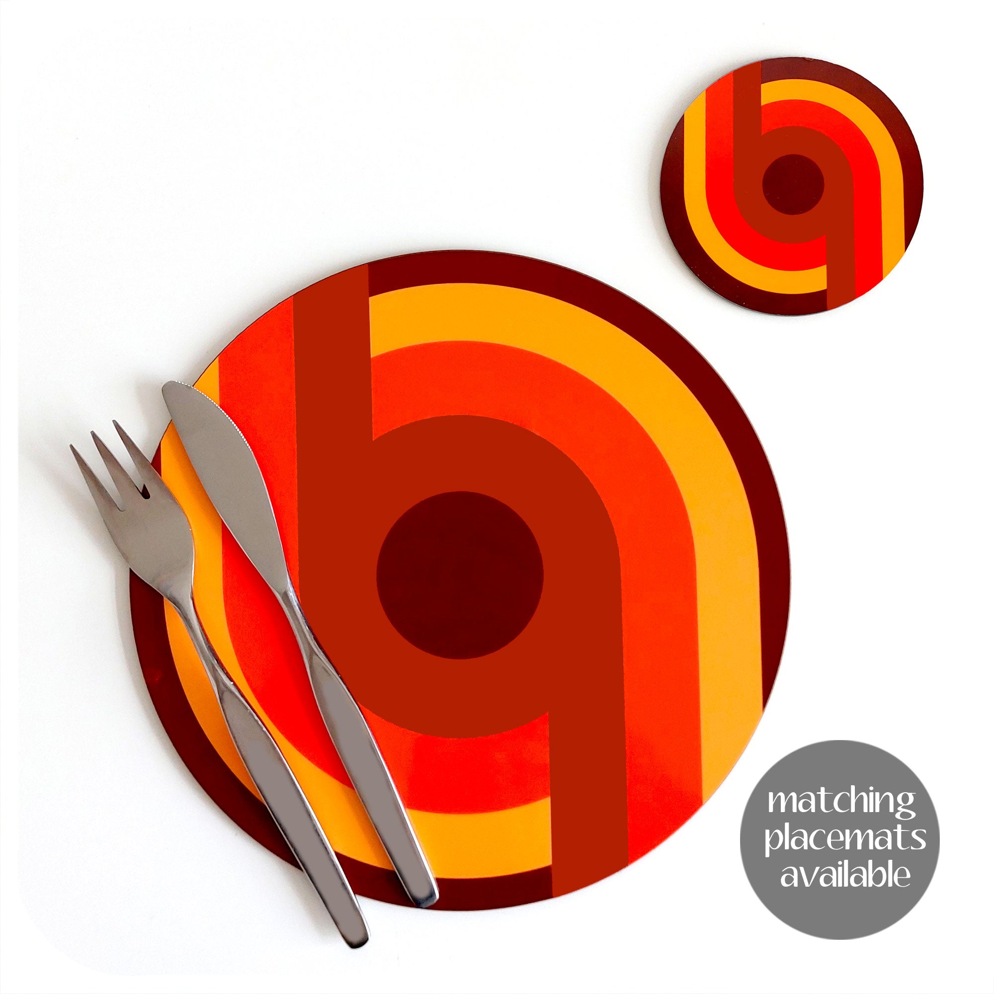 70s Supergraphic style round placemat  and matching coaster on a white table with vintage mid century knife and fork. Text on image reads "matching placemats available" | The Inkabilly Emporium