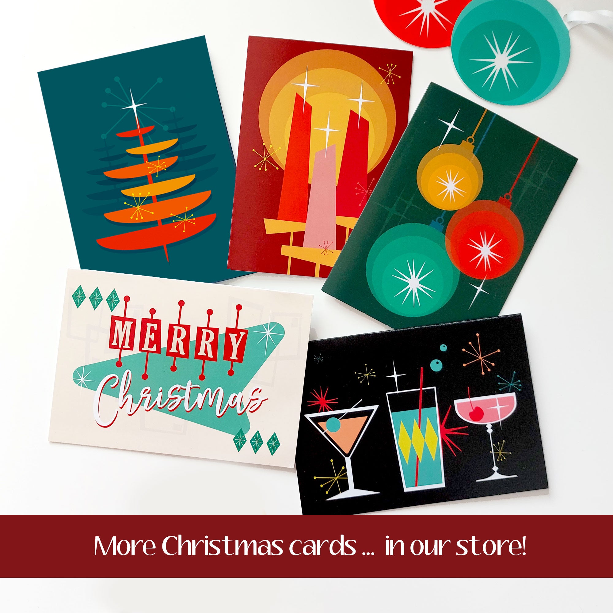 5 retro style Christmas cards lie scattered on a white table. Text reads "More Christmas cards in our store!" | The Inkabilly Emporium
