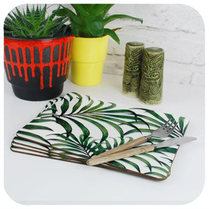Palm Leaf Print Placemats, set of 4 on a table with tropical plants and Tiki cruet set | The Inkabilly Emporium
