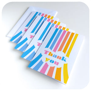 Pack of four Retro Rainbow Thank You Cards on a white table, with envelopes | The Inkabilly Emporium