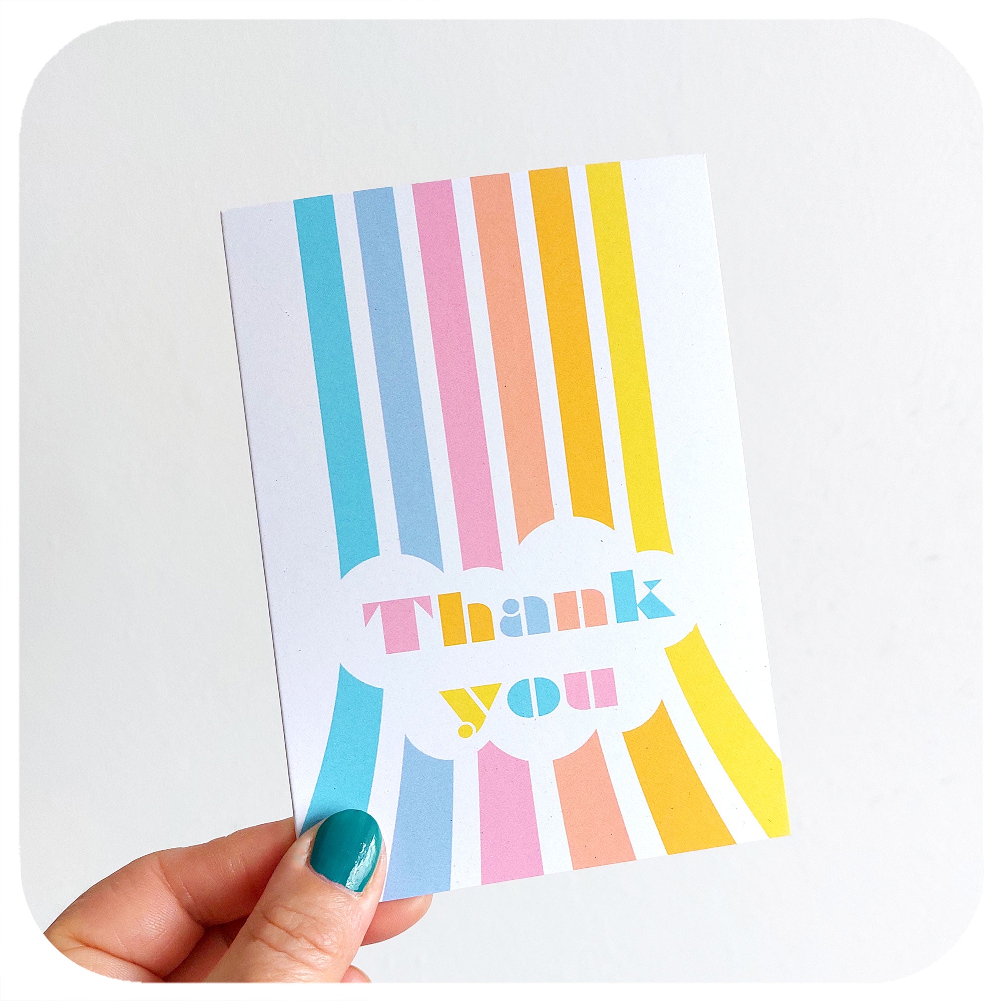 Pastel Retro Rainbow Thank You Card being held in front of a white background | The Inkabilly Emporium