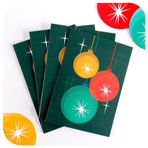 Four Retro Baubles Christmas Cards lie on a white table with 50s style Christmas decorations | The Inkabilly Emporium
