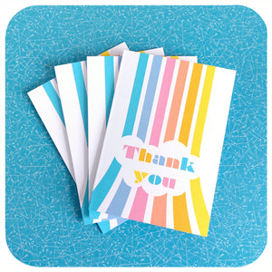 Four Thank You Cards featuring retro pastel rainbows, on a blue table | The Inkabilly Emporium