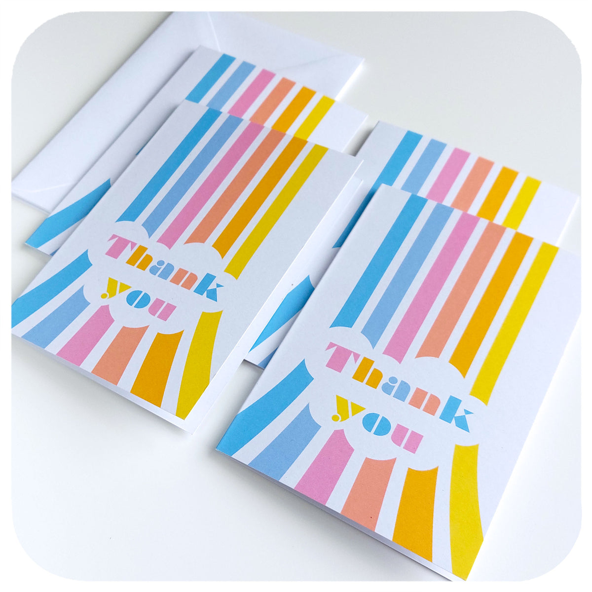 Pack of four Thank You Cards featuring retro rainbows in pastel colours, on a white table | The Inkabilly Emporium