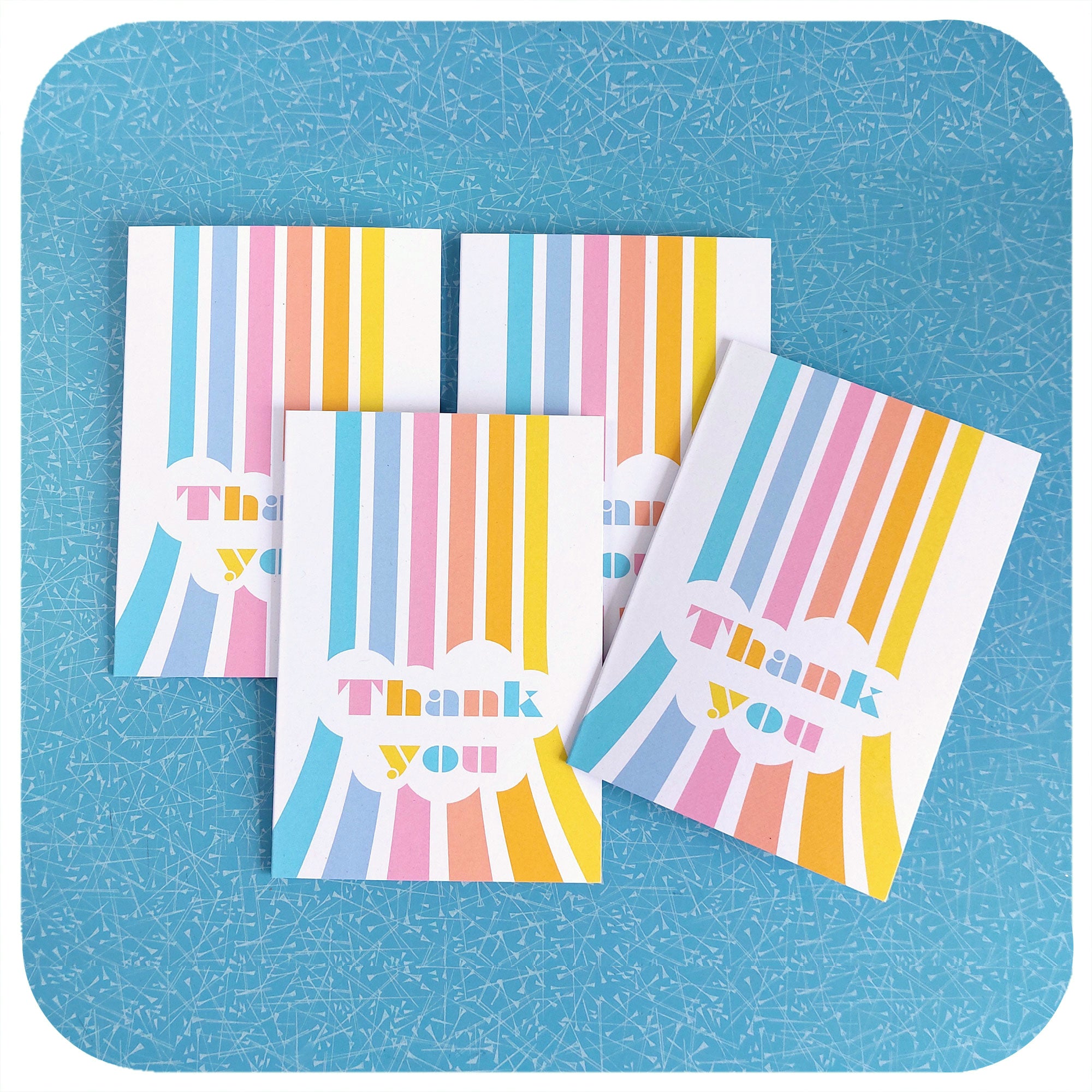 Four Retro Rainbow Thank You Cards on a blue table | The Inkabilly Emporium