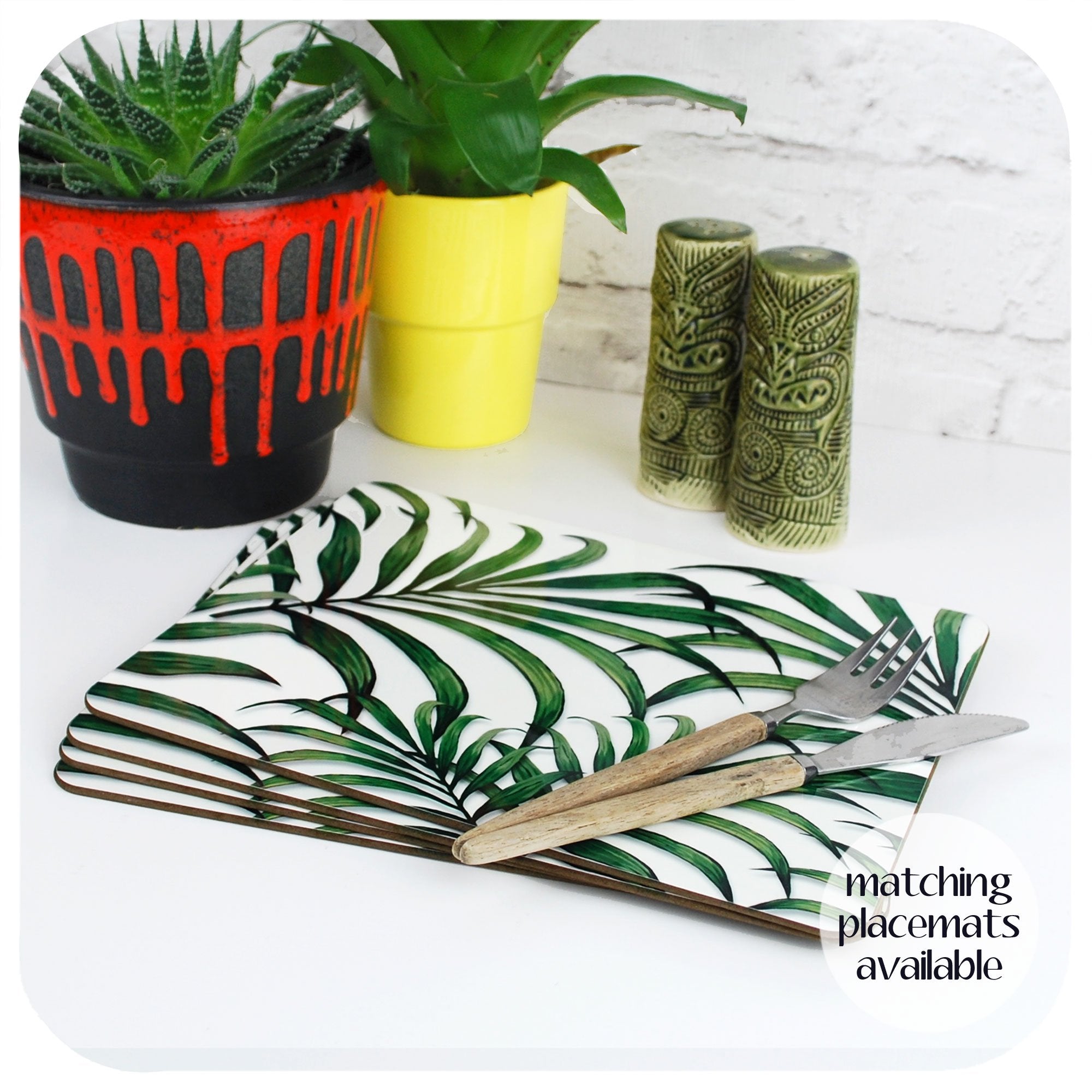 Palm Leaf Placemats, set of 4 on a table with tropical plants and tiki cruet set | The Inkabilly Emporium