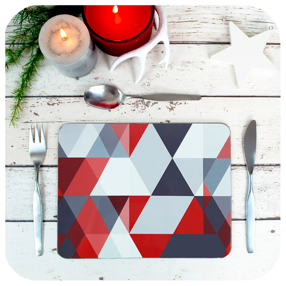 Scandi Geometric Placemats in Red & Grey, set on a table with Christmas candles and decorations | The Inkabilly Emporium
